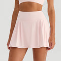 Person wearing a light pink skirt on a plain background