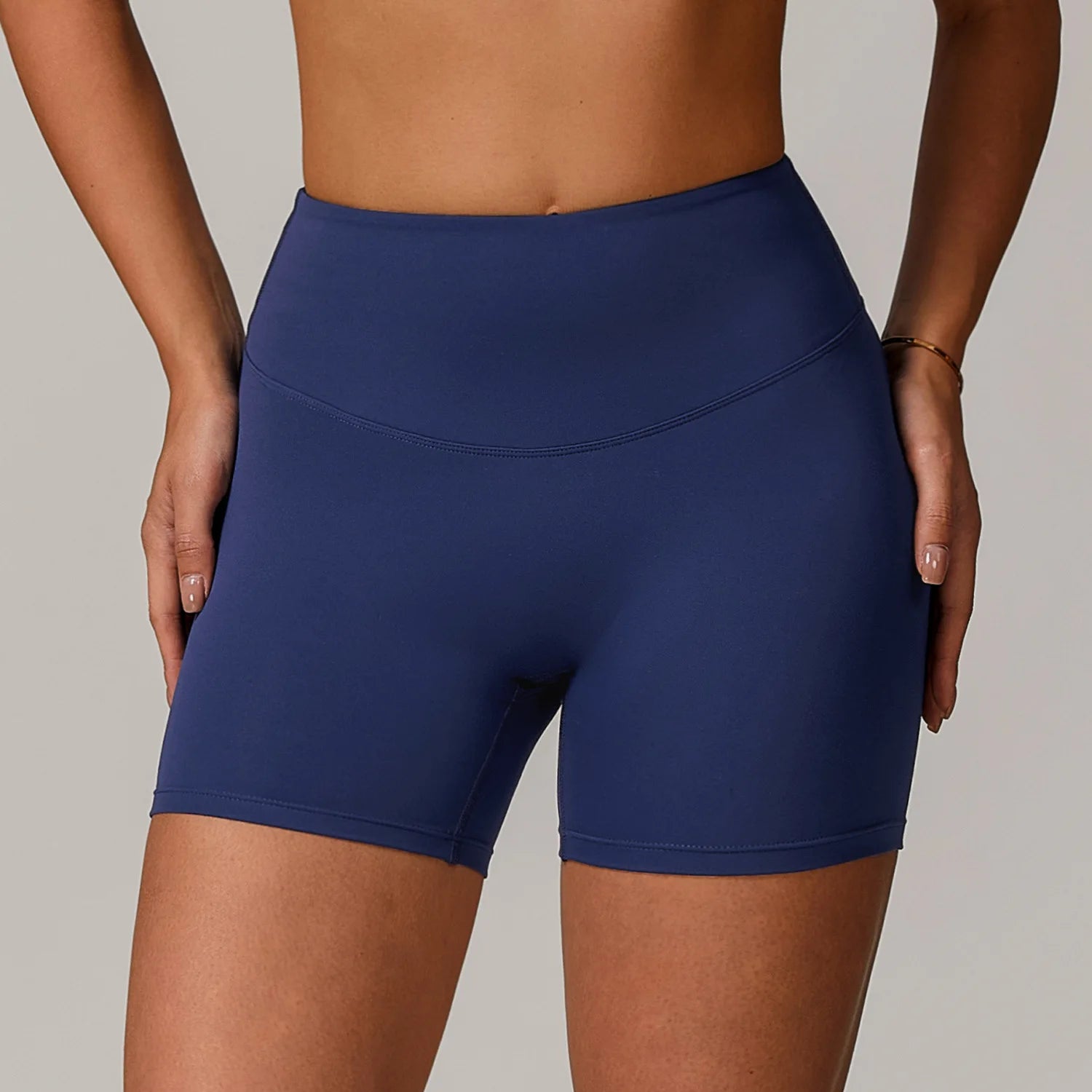 Navy blue athletic shorts worn by a person on a neutral background